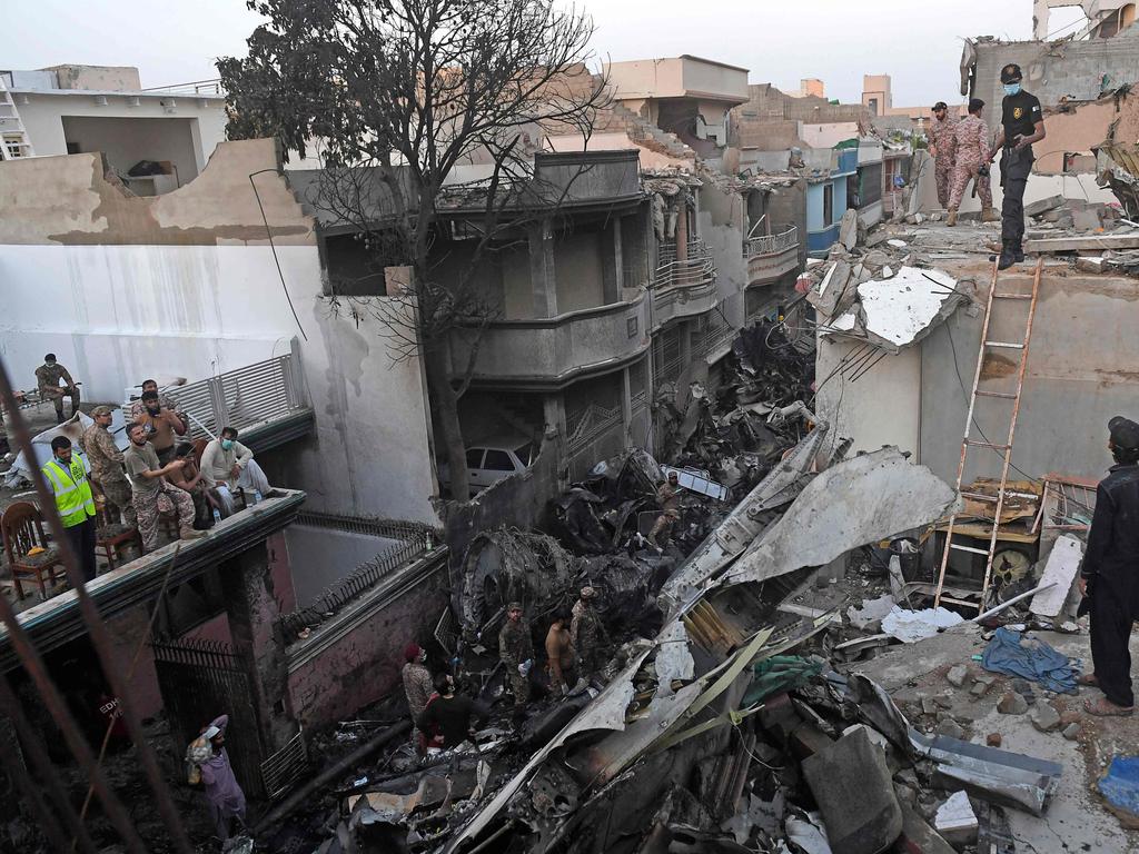 Security personnel search for victims in the wreckage. Picture: AFP