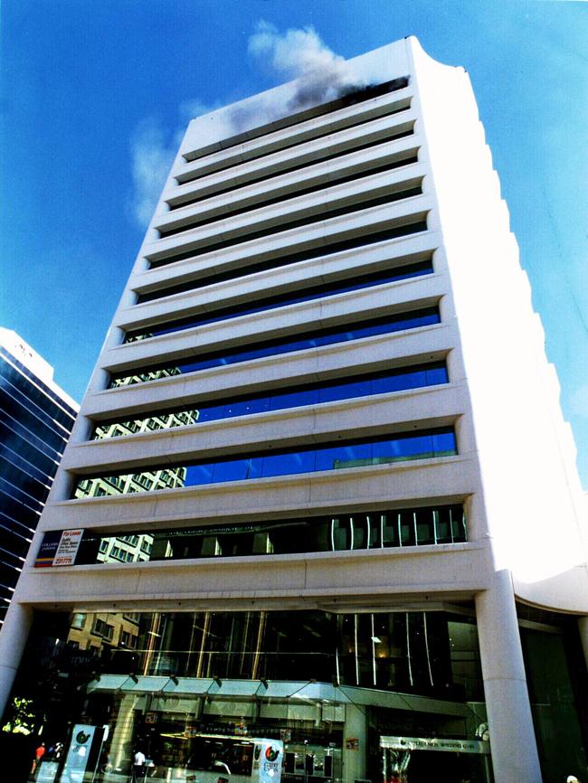 Smoke billows from 12th floor of the NCA building in Waymouth St after the parcel bomb sent by Domenic Perre exploded. Picture: Chris Mangan