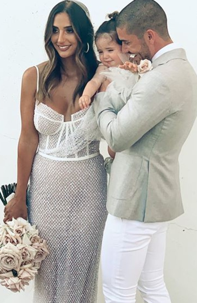 Thessy and Georgio on their wedding day with their daughter Zani. Image supplied.