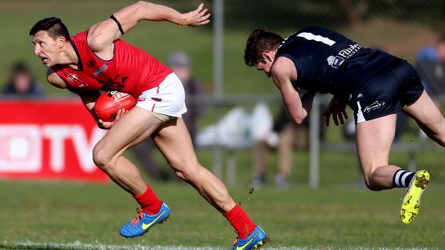 Norwood’s Patrick Levicki gets away from South Adelaide’s Brett Eddy. Picture: Calum Robertson