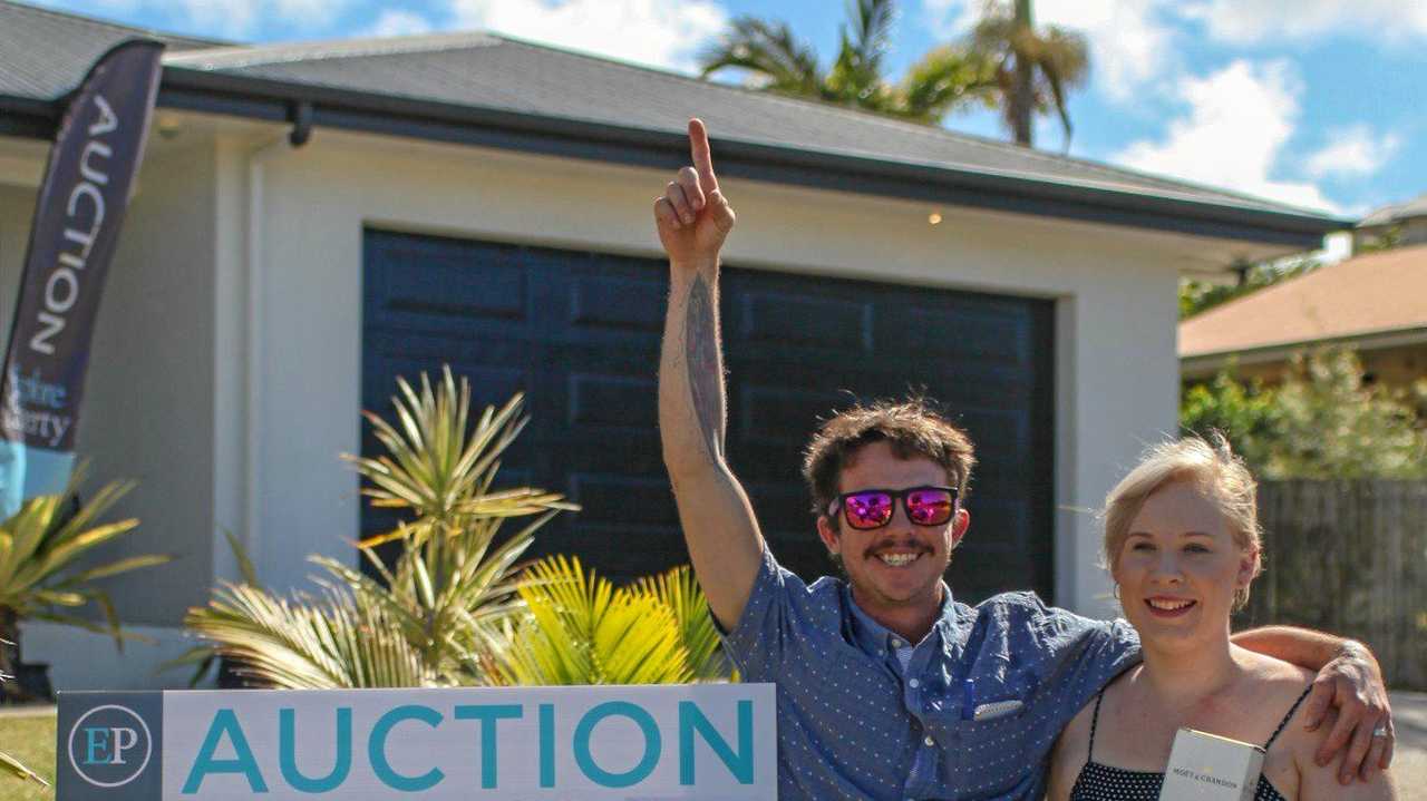 Kerry and Katie Warren just after snapping up their new home, 29 Cinnamon Drive, Glenella, at an Explore Property auction over the weekend. Picture: Navarone Farrell