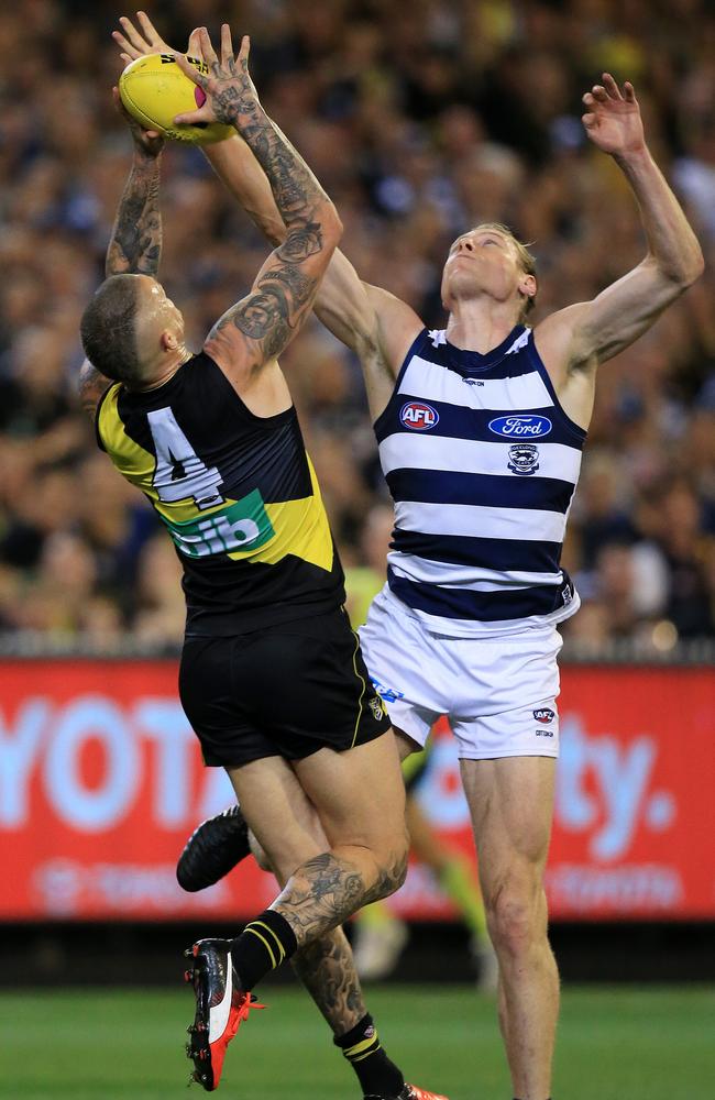 Dustin Martin marks but receives a corkie from Mark Blicavs. Picture: Mark Stewart