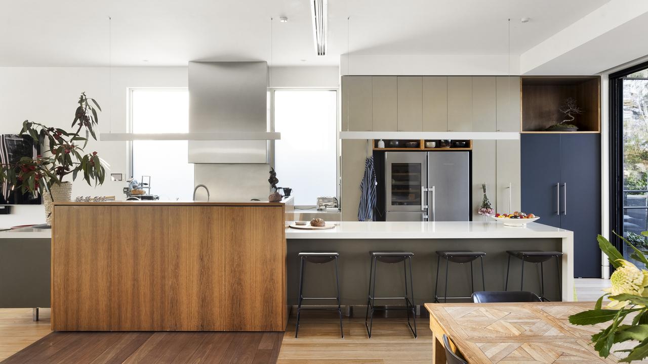 The kitchen is fitted with stainless steel benches and a 110mm Wolf stove.