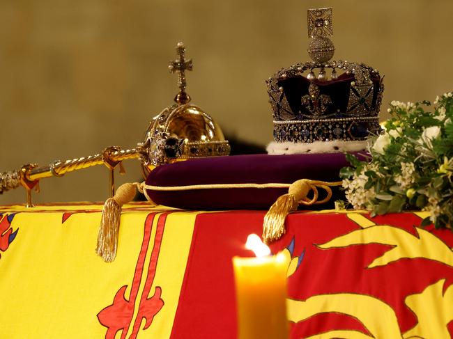 LONDON, ENGLAND - SEPTEMBER 15: The coffin of Queen Elizabeth II, draped in the Royal Standard with the Imperial State Crown and the Sovereign's orb and sceptre, lying in state on the catafalque in Westminster Hall, at the Palace of Westminster, ahead of her funeral on Monday, on September 15, 2022 in London, England. (Photo Odd Andersen - WPA Pool/Getty Images)