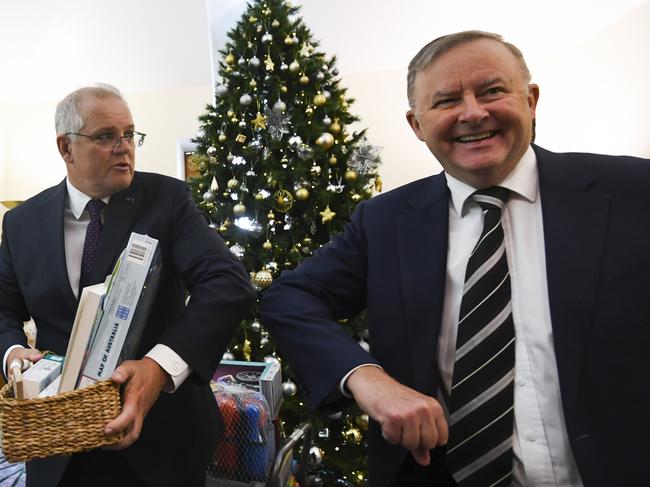 Scott Morrison and Anthony Albanese deliver presents at the Kmart Wishing tree launch at Parliament House. Picture: AAP Image/Lukas Coch/