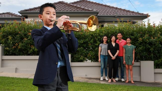 Benjamin Su, 11, from Concord West will stand at the end of his Concord West street to sound the Last Post on his trumpet – much to the pride of his family (pictured L-R behind) Amelia, 14, mum Pauline, dad David and Jacqueline, 13. Picture: Justin Lloyd