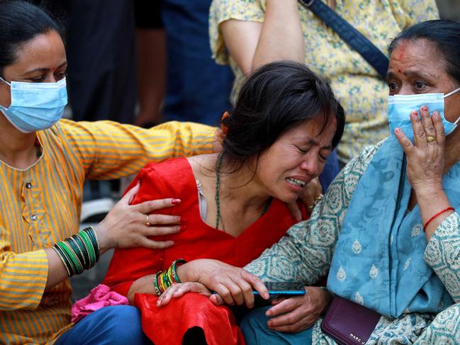 Relatives of the deceased who died in the Saurya Airlines' plane crash, mourn at a hospital in Kathmandu. Picture: AFP