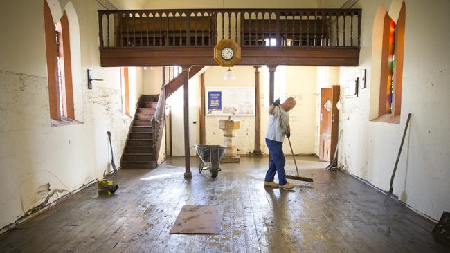 Clean-up: The interior of the water-ravaged St Mark’s Anglican Church in Picton. Picture: News Cor.