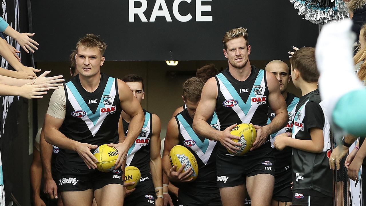 AFL - Round 4 - Port Adelaide v Richmond at The Adelaide Oval. Dual Captains Ollie Wines and Tom Jonas lead the team out. Picture SARAH REED