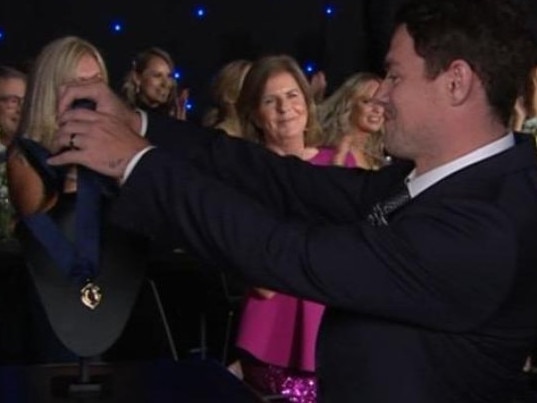 Lachie Neale presents himself the Brownlow Medal.