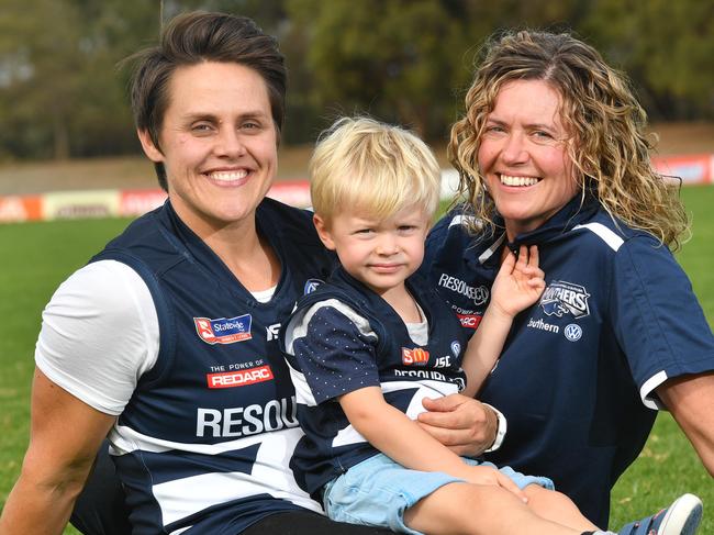 South Adelaide player Courtney Gum with son Busby Mac and women's coach/ partner Krissie Steen pose for a photograph at Hickinbotham Oval, Noarlunga Downs, Adelaide on Saturday the 28th of April 2018. (AAP/ Keryn Stevens)