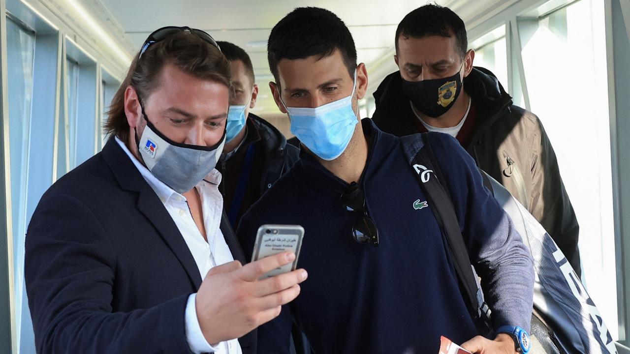 A man takes a selfie with Serbian tennis player Novak Djokovic as he arrives at Nikola Tesla Airport after being deported. REUTERS/Christopher Pike