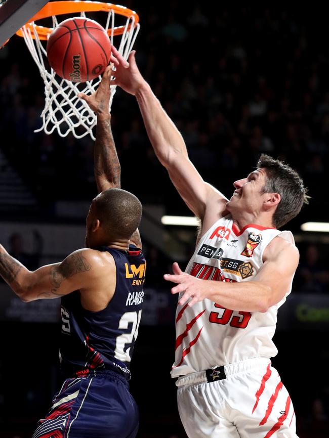 36er Jerome Randle has his shot blocked by Wildcat Damian Martin. Picture: AAP Image/Kelly Barnes