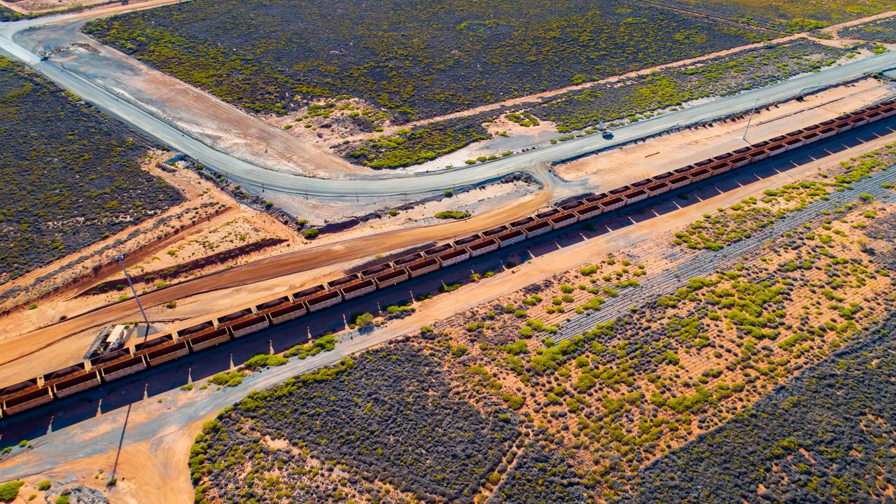 Freight wagons filled with iron ore travel along rail tracks near Port Hedland, WA. Picture: Ian Waldie/Bloomberg via Getty Images