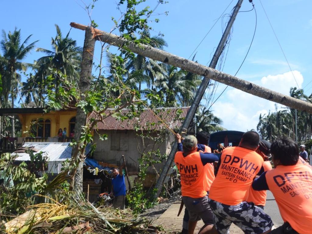 Workers pull a fallen electric pylon damaged at the height of Typhoon Phanfone in Salcedo town in Eastern Samar province. Picture: AFP