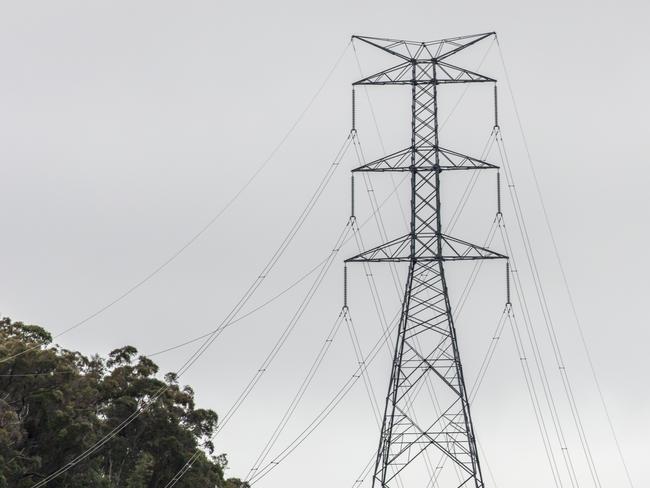 Photograph of a large steel transmission tower and associated cables running through a valley in regional New South Wales in Australia