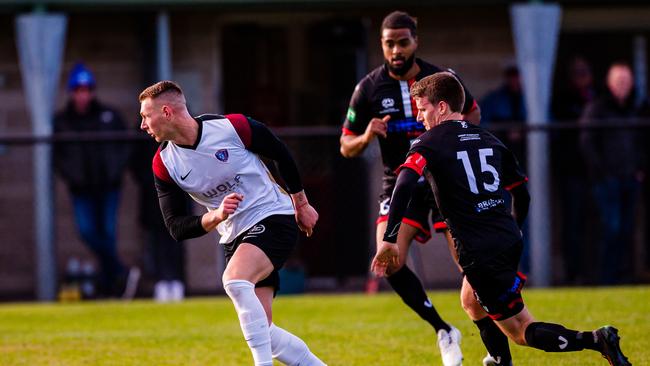 Nick Morton (South Hobart) gets the ball away from Josh Mathie (Clarence Zebras) earlier in the season. Picture: Anthony Corke