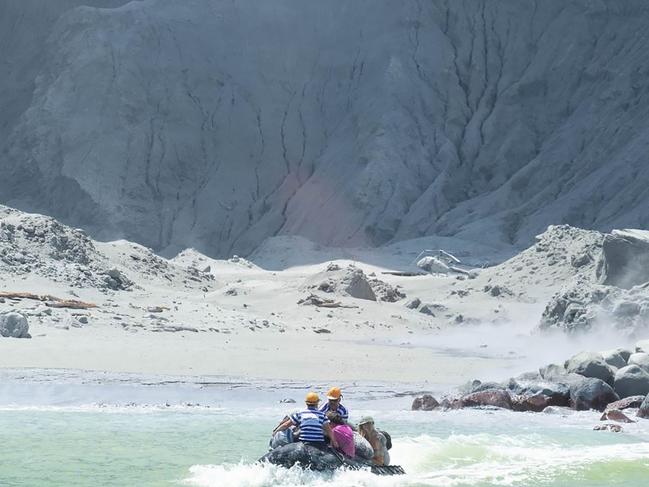 White Island Tour operators rescuing people minutes after the volcano on New Zealand's White Island erupted. Picture: Michael Schade/AFP