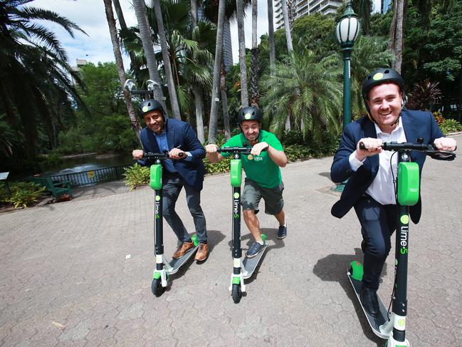 Mayank Mittal, Vinicius Machado Campos and Mitchell Price on Lime scooters in the Brisbane Botanical Gardens. Picture: AAP/Claudia Baxter