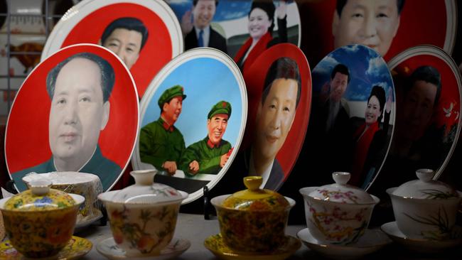 Decorative plates featuring images of Chinese President Xi Jinping and late communist leader Mao Zedong are displayed at a shop in Beijing on November 9, 2021. Picture: AFP