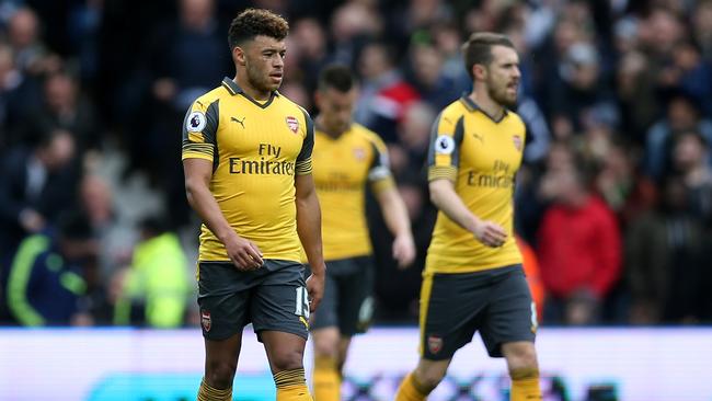 Alex Oxlade-Chamberlain of Arsenal (L) looks dejected after West Bromwich Albion score.