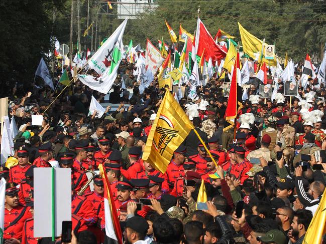 Supporters of the Hashed al-Shaabi paramilitary force attend the funeral procession of those army chiefs killed in a US air strike. Picture: AFP