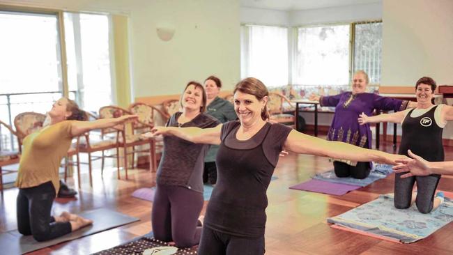 FIT TOGETHER: Staff at Dougherty Villa enjoy an afternoon of Pilates as part of their 'Biggest Loser' initiative. Picture: Tim Jarrett