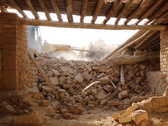 Levelled ... a bulldozer, seen in the background, is used to brutally dismantle the Saint Eliane Monastery. Picture: Islamic State militant website via AP