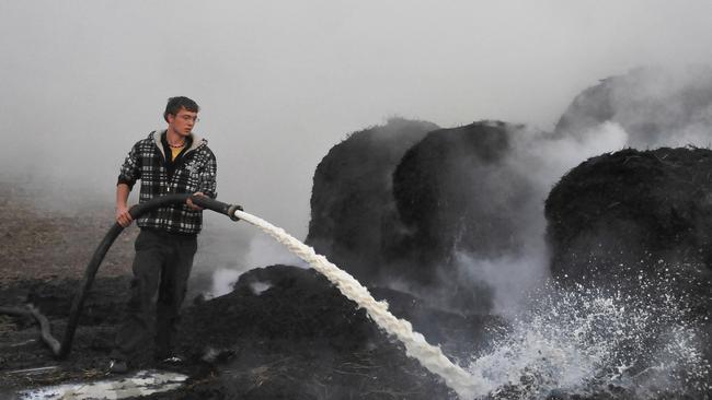 A dairy farmer spraying milk on burning bails of hay during protests in a field near the eastern German city of Magdeburg in 2009. AFP PHOTO DDP/ MICHAEL KLUG