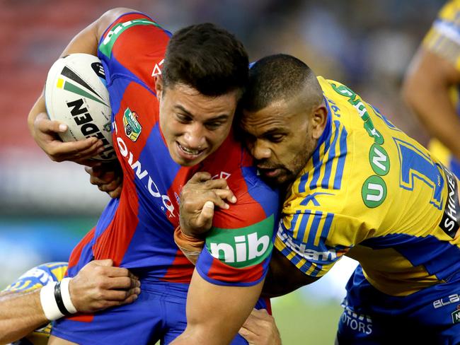 Newcastle's Joseph Tapine tackled by Parramatta's Manu Ma'u during the round 6 NRL game between the Newcastle Knights and the Parramatta Eels at Hunter Stadium .Picture Gregg Porteous