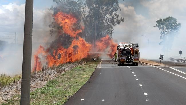 A fire that jumped Gladstone Benaraby Road at Glen Eden has shut the road to traffic. Picture: Rodney Stevens