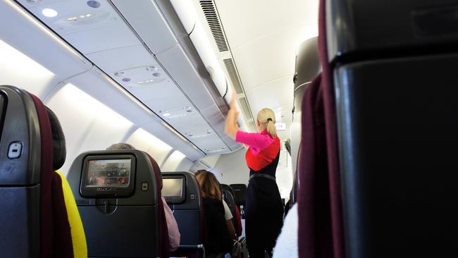 Qantas has no plans to charge extra for carry-on but other airlines such as United and Air Canada are imposing fees for using the overhead lockers. Picture: iStock