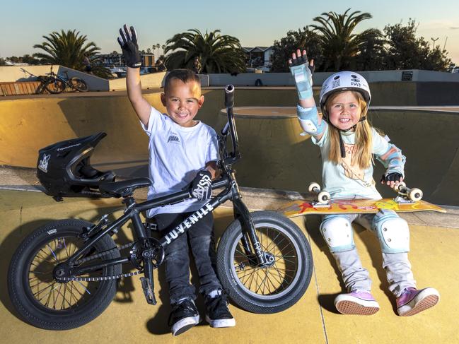 Tyler, 5, and Neave, 4, celebrate the lifting of restrictions at the St Kilda skate park. Picture: David Geraghty