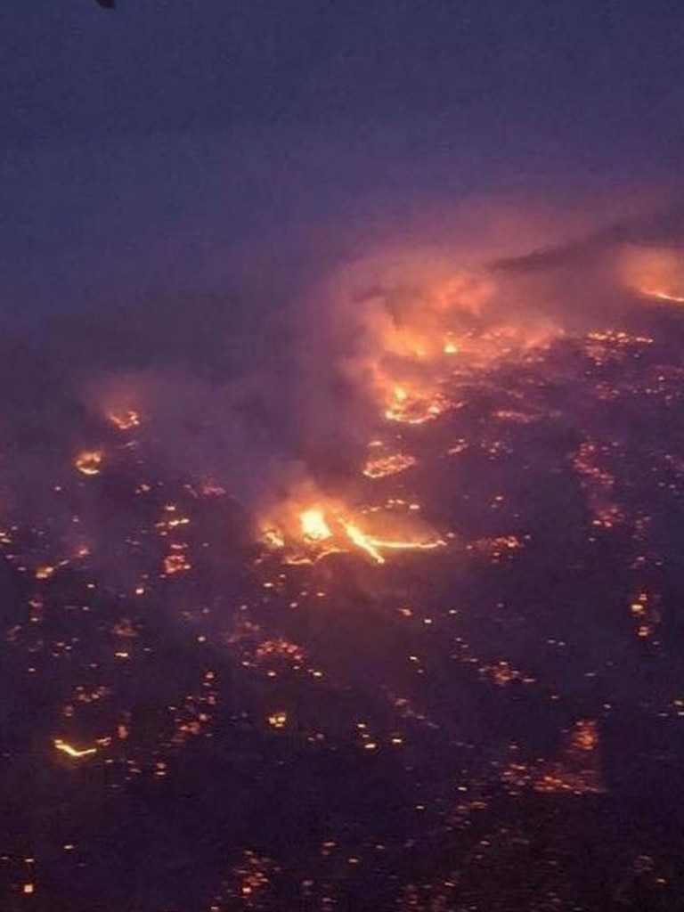 A photo taken flying into Adelaide showing fire burning in the Adelaide Hills. Picture: Melissa Ellery