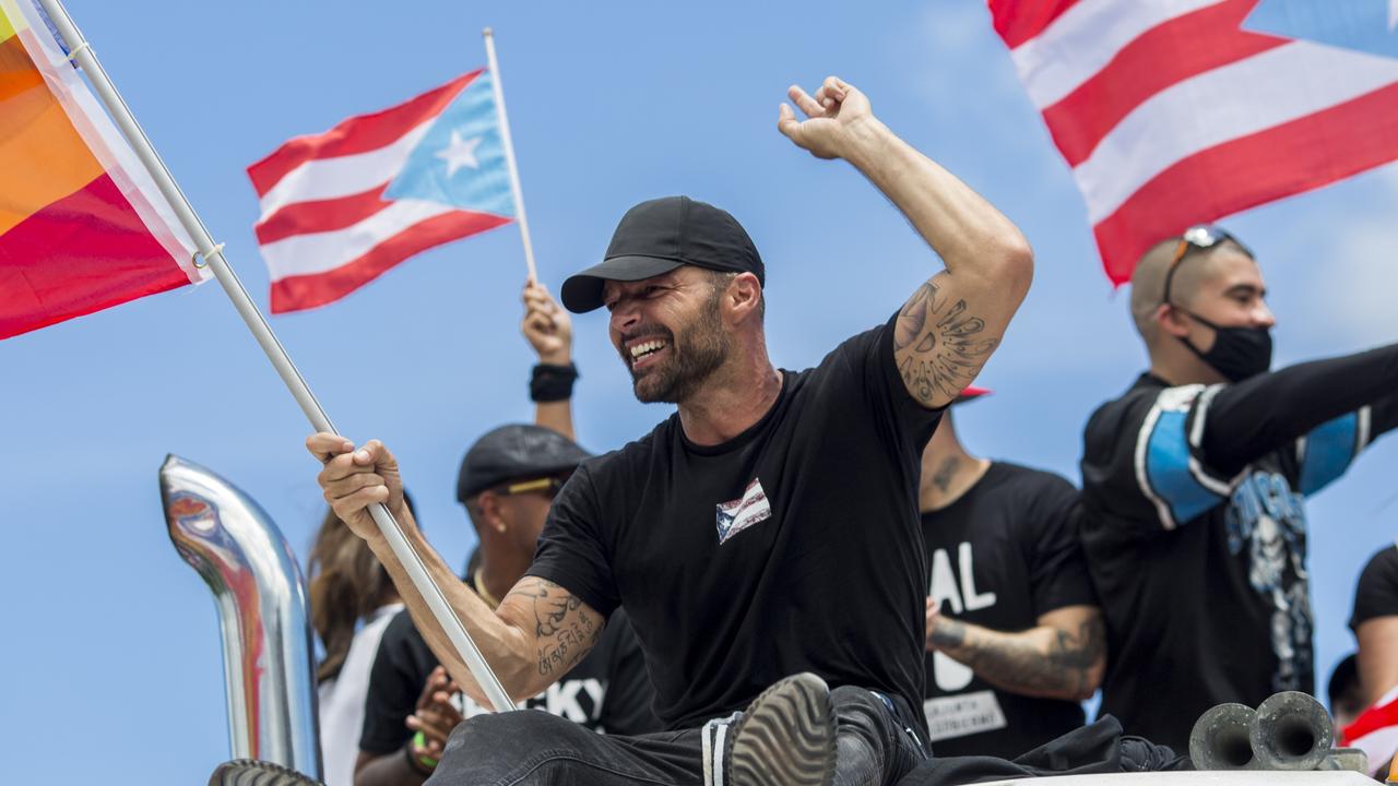 Ricky Martin was photographed flying a gay pride flag as he joined the protest. Picture: AP