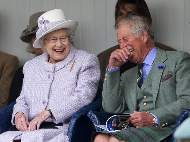 Her Majesty shares a laugh with Prince Charles at the 2012 Braemar Highland Gathering. Picture: Getty Images