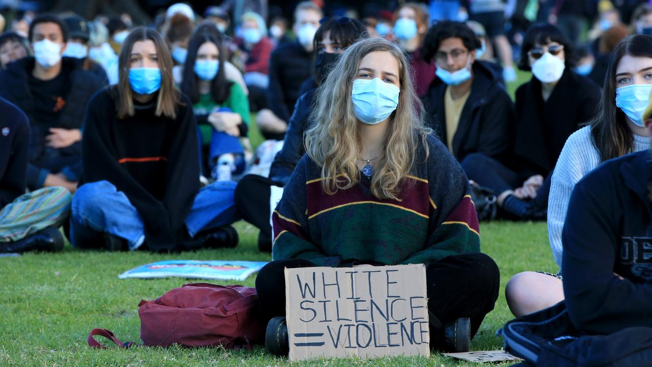 Most protesters also wore masks, which were being distributed on the way into The Domain. Picture: Damian Shaw