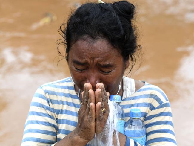 A woman grieves in the flood ravaged village in Sanamxai, Attapeu province. Picture: AFP