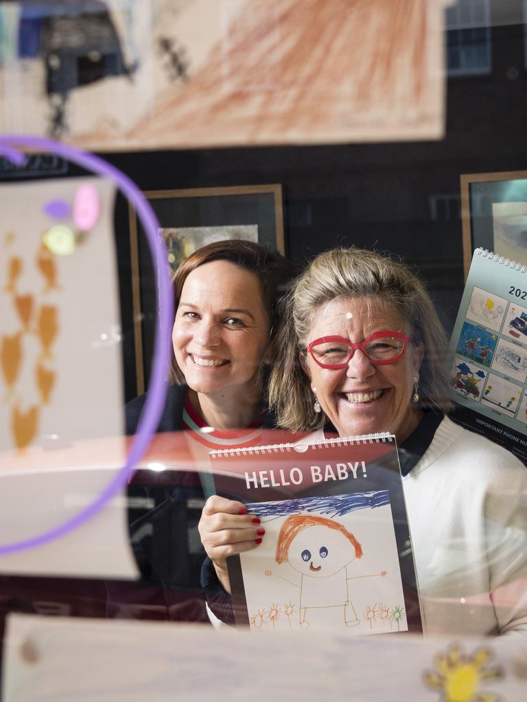 The Lighthouse Toowoomba captain Emily MacManus (left) and lighthouse keeper Emma Mactaggart with Hello Baby! 2023 calendar and entries in the 2024 edition. Picture: Kevin Farmer