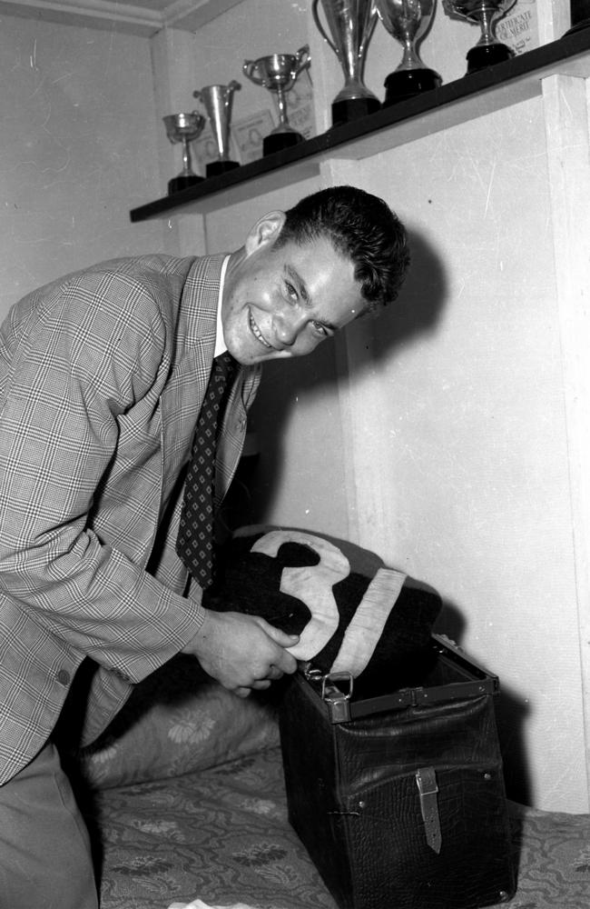 Melbourne's Ron Barassi packs his jumper before his first VFL game.