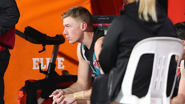 ADELAIDE, AUSTRALIA - SEPTEMBER 13: Todd Marshall of the Power on the bench while Club Dr's disuss his recent test during the 2024 AFL Second Semi Final match between the Port Adelaide Power and the Hawthorn Hawks at Adelaide Oval on September 13, 2024 in Adelaide, Australia. (Photo by Sarah Reed/AFL Photos via Getty Images)