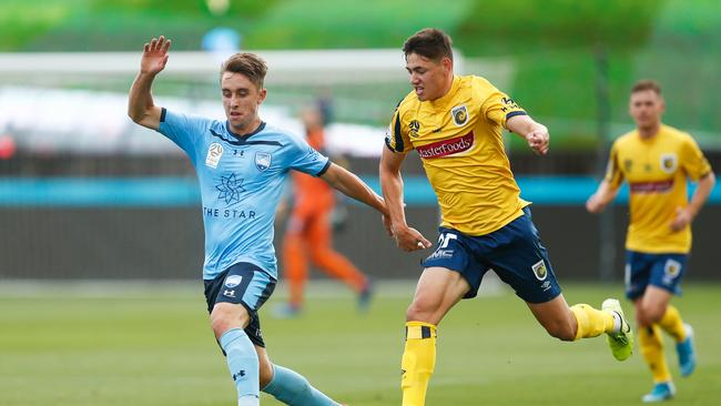 Adam Le Fondre of Sydney FC competes with Lewis Miller of the Mariners.