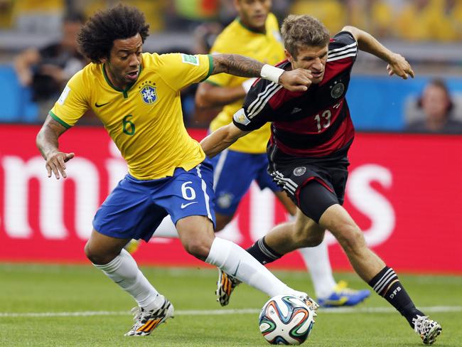 Brazil’s Marcelo and Germany’s Thomas Mueller challenge for the ball during the World Cup semi-final. Picture: AP Photo/Frank Augstein