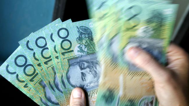 Australian one-hundred-dollar bills are displayed for a photograph in Sydney, Australia, on Wednesday, April 18, 2007. The Australian dollar dropped the most in two weeks against the yen as a drop in U.S. stocks prompted investors to pare investments funded by loans in the Japanese currency. Photographer: Grant Turner/Bloomberg News