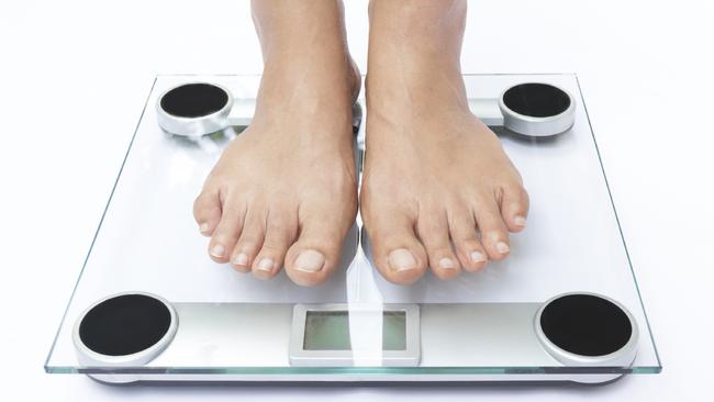 Generic photo of feet on bathroom scales. Picture: iStock