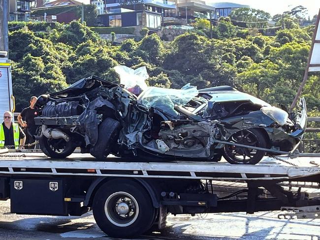 SYDNEY, AUSTRALIA - NewsWire Photos - 24 FEBRUARY, 2025: A person has been trapped inside their “completely crushed” vehicle after colliding with a truck on the Spit Bridge, with Sydney commuters warned to expect major delays. , , Emergency services were called to the Spit Bridge in Manly at about 7.30am Monday after reports a car was crushed underneath truck during a collision, trapping a person inside the vehicle.  Picture: NewsWire / Ben Symons