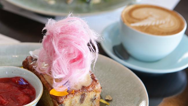 Coffee with a Raisin Pain au lait French Toast and rhubarb compote is a popular choice at Lady Marmalade Cafe, Stones Corner who features in The Courier-Mail’s shortlist of Best cafes for coffee. Picture: AAP/Ric Frearson