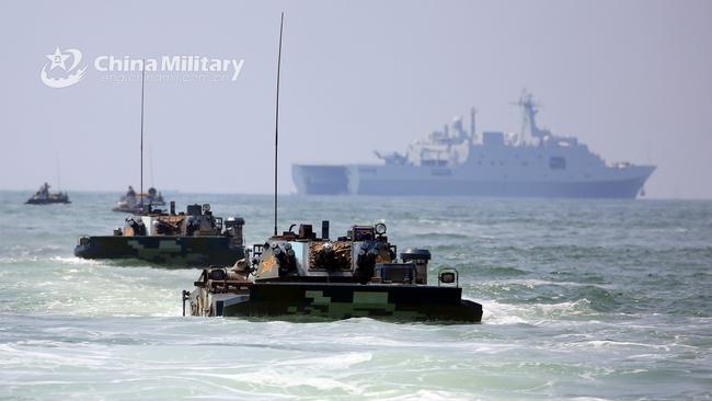 Chinese amphibious armored vehicles make their way to the beach-head during maritime amphibious assault training. Picture: Supplied