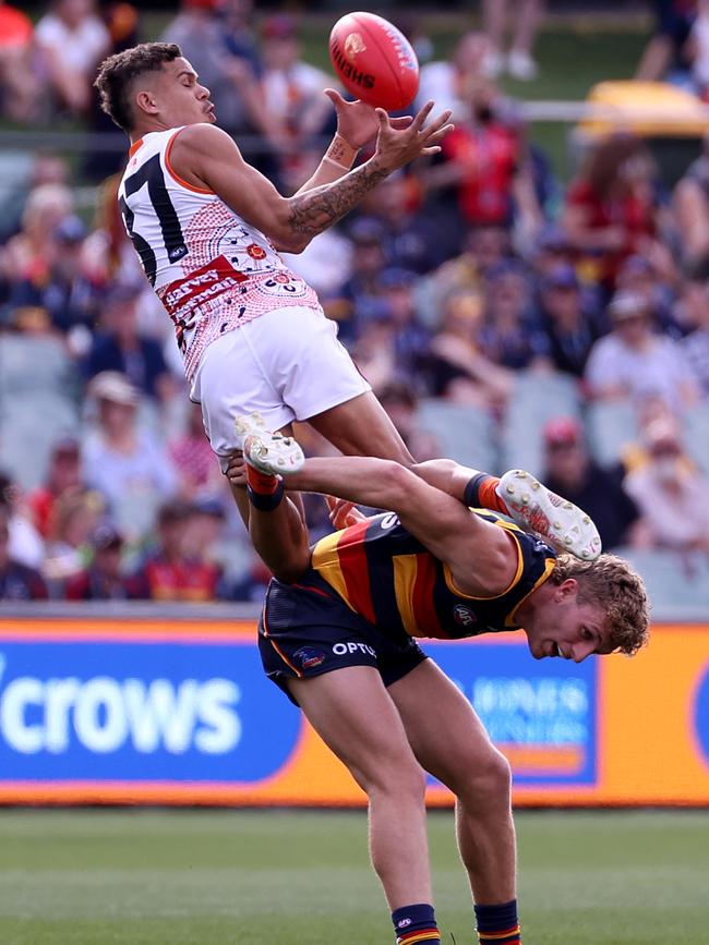 Hill flies for the screamer over Andrew McPherson. Picture: James Elsby/AFL Photos