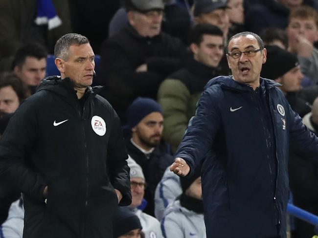 Chelsea head coach Maurizio Sarri gestures when looking at the fourth official during the English FA Cup fifth round soccer match between Chelsea and Manchester United at Stamford Bridge stadium in London, Monday, Feb. 18, 2019. (AP Photo/Alastair Grant)